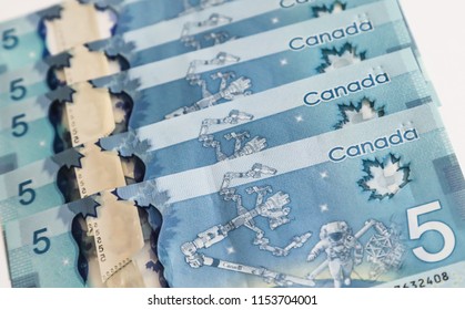 TORONTO CANADA - JULY 30, 2018: Canadian $5 Dollar Banknotes. The Current Five-Canadian Dollar Note, Part Of The Frontier Series, Is Predominantly Blue In Color