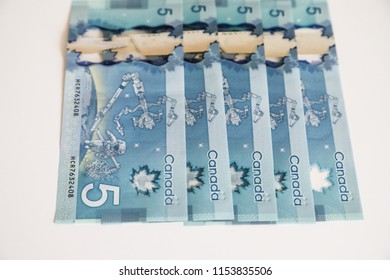 TORONTO CANADA - JULY 30, 2018: Canadian $5 Dollar Banknotes. The Current Five-Canadian Dollar Note, Part Of The Frontier Series, Is Predominantly Blue In Color