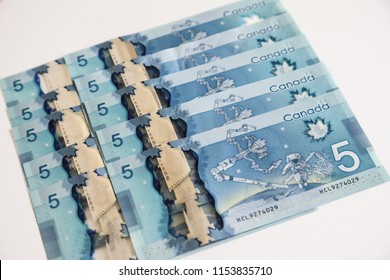 TORONTO CANADA - JULY 30, 2018: Canadian $5 Dollar Banknotes. The Current Five-Canadian Dollar Note, Part Of The Frontier Series, Is Predominantly Blue In Color