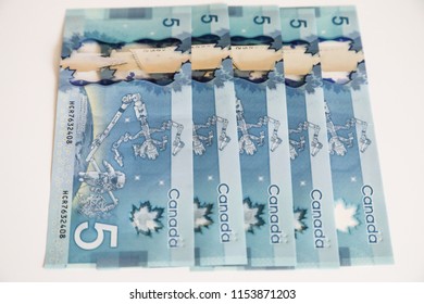 TORONTO CANADA - JULY 30, 2018: Canadian $5 Dollar Banknotes. The Current Five-Canadian Dollar Note, Part Of The Frontier Series, Is Predominantly Blue In Color