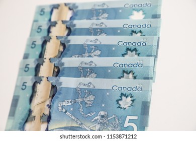 TORONTO CANADA - JULY 30, 2018: Canadian $5 Dollar Banknotes. The Current Five-Canadian Dollar Note, Part Of The Frontier Series, Is Predominantly Blue In Color