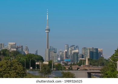 Toronto, Canada - Jun 9, 2021: Toronto City Skyline With New High Rise Buildings Development In Front Of CN Tower. New Real Estate And Housing Development Concept. Sunny Summer Day, Clear Sky.