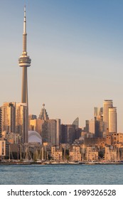 Toronto, Canada - Jun 9, 2021: Toronto City Waterfront Skyline With Marina And New Buildings Development In Front Of CN Tower Lit Up In Sunset Hour. New Real Estate And Housing Development Concept.