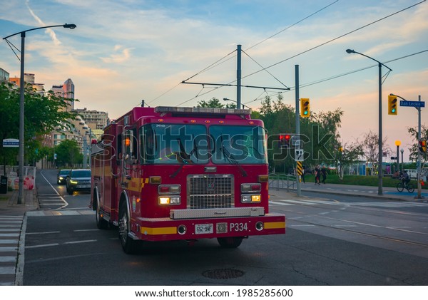 TORONTO, CANADA - JUNE 03, 2021:Firefighter\
vehicle of Toronto Fire Department on Queen Quay West in Downtown\
Toronto at sunset\
