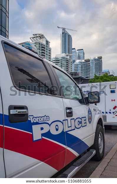 TORONTO, CANADA - JUNE 04, 2018: Close up of\
the side doors of a Toronto Police track with  lettering and logo\
with the city urban\
background