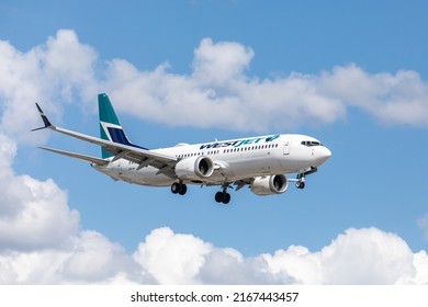 Toronto Canada, June 10, 2022; Quarter view of Westjet Boeing 737  jet airliner arriving for landing at Toronto Pearson airport YYZ