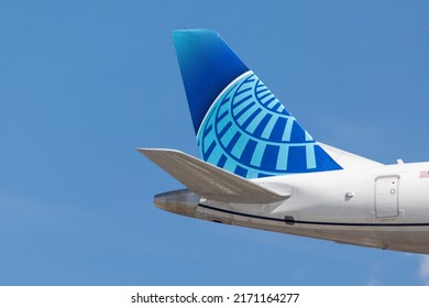 Toronto Canada, June 10, 2022; Rudder and tail plane logo of a United Airlines Embraer jet airliner arriving for landing at Toronto Pearson airport YYZ