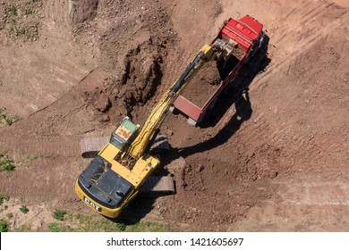 Toronto, Canada - June 11, 2019: Caterpillar Digging and Dumping Soil into a Big Truck on a Construction Site