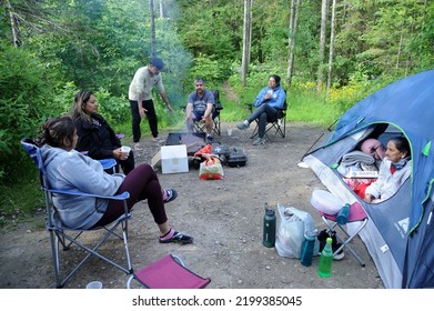 Toronto Canada June 22 2022 Indian Happy Family Having Great Time Relaxing Near Campfire And Having Fun In Forest