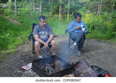 Toronto Canada June 22 2022 Indian Happy Family Having Great Time Relaxing Near Campfire And Having Fun In Forest