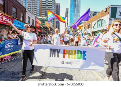 TORONTO, CANADA - JUNE 25, 2017: SHOPIFY Employees March With Banner At 2017 Toronto Pride Parade. 