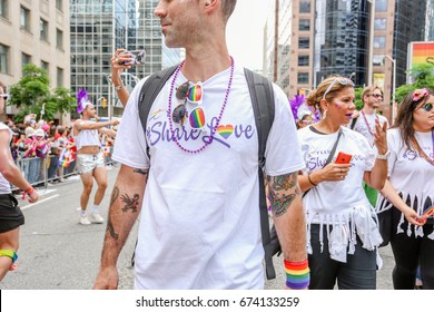 TORONTO, CANADA - JUNE 25, 2017: TELUS employees march at 2017 Toronto Pride Parade. 