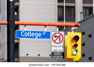 Toronto, Canada - March 4, 2019: College Street Sign With Traffic Light Is Seen In Downtown Toronto, Canada. College Street Is A Principal Arterial Thoroughfare In Downtown Toronto. 