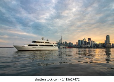 Toronto, Canada - May 24, 2019 : People On An Evening Sunset Party Boat Cruise Leaving Inner Harbour With The Toronto Skyline In The Background. 