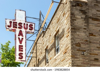 Toronto, Canada, May 31, 2021; The icon, faded, Jesus Saves cross shaped neon sign at Faith Impact Ministry on St Clair in Toronto