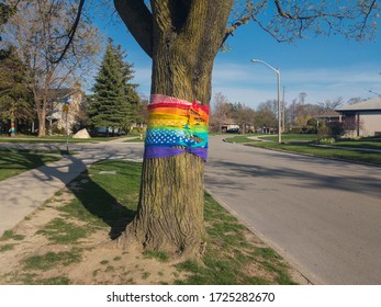 Toronto, Canada - May 6, 2020: Tree Wrapped In Rainbow Colored Ribbons In Appreciation And Support Of Front Line, Essential Workers And Volunteers Fighting Corona Virus During Covid 19 Pandemic.