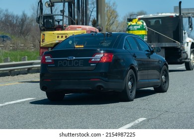 Toronto Canada May 7 2022: Close View Of OPP Unmarked Undercover Police Cruiser Interceptor Following A Car On The Highway. Dangerous, Careless Driving, Speeding, DUI, Traffic Violations Concept.