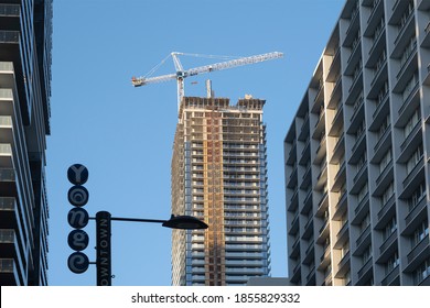 Toronto, Canada - Nov 14, 2020: Construction Cranes On Yonge Street By Modern High Rise Condo And Office Building That Are Being Built. New Housing, City Developments, Real Estate Market Concept.