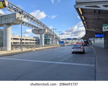 Toronto, Canada - Nov 19 2021: Police car with lights on at passenger pick up drop off area at Toronto International Pearson Airport YYZ (GTAA)