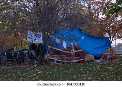 Toronto, Canada - Oct 27, 2020: Sign Winter Is Coming We Need Permanent Housing Now At Homeless Tent Camp At Trinity Bellwods Park. Homelessness, Injustice And Social Issues Concept.