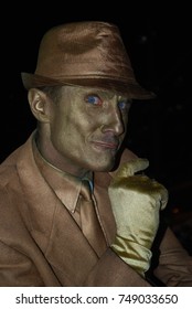 TORONTO, CANADA - October 27, 2017 - Gold Mime, Street Artist, Living Statue, Man Posing In Frozen Position And Will Only Move When Money Donation Is Given. Artist At Dundas Square, Downtown, At Night