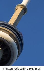 Toronto, Canada - October 8, 2013: A Closeup Of The CN Tower Showing People Doing The Walk Around The Edge Of The Building On October 8th 2013