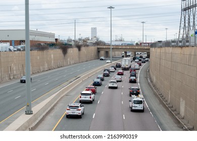 Toronto, Canada-June 2022:Urban Transportation - Rush Hour Traffic Of Cars And Trucks On A City Divided Roads. Metropolis Activity Heading Towards An Overpass. A Traffic Jam Of Vehicle Transportation.