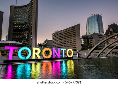 Toronto city hall and Toronto Sign in downtown at twilight, in Toronto, Ontario, Canada