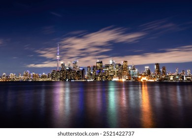 Toronto city skyline at night with water reflections - Powered by Shutterstock