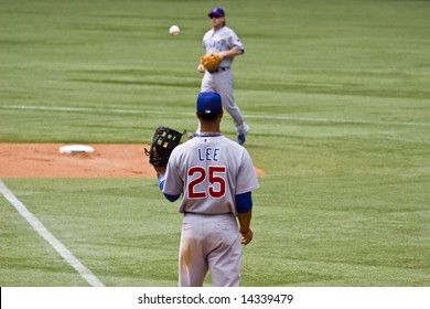 TORONTO - JUNE 14:  Derek Lee #25 Catches The Ball From Mike Fontenot #17 During The Chicago Cubs Vs. Toronto Blue Jays Game At The Rogers Centre June 14, 2008 In Toronto, Ontario.  Chicago Won 6-2.