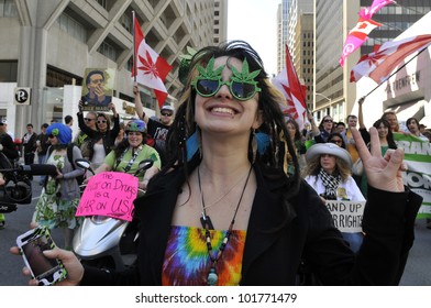 TORONTO - MAY 5: A Marijuana activist showing victory sign  during the 14th annual Global Marijuana March on May 5  2012 in Toronto, Canada.