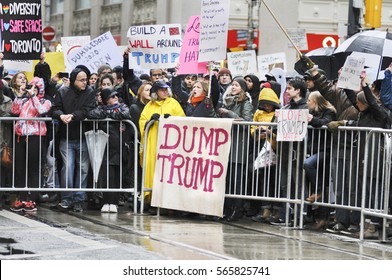 TORONTO - NOVEMBER 19: Protesters with signs saying "Dump Trump " during a protest in front of Trump Tower on November  19, 2016 in Toronto, Canada.