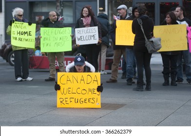 TORONTO - NOVEMBER 22: People With Colorful Posters Gathered At Yonge & Dundas To  Support The Incoming Syrian Refugees Into Canada During A Solidarity Rally On November 22, 2015 In Toronto,Canada.