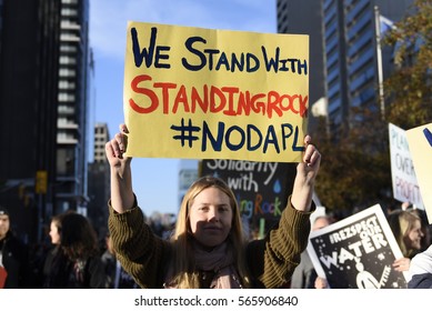 TORONTO - NOVEMBER 5: A Woman Walking With A Solidarity Message During A Rally With The Dakota Access Pipeline Protesters On November 5, 2016 In Toronto, Canada.