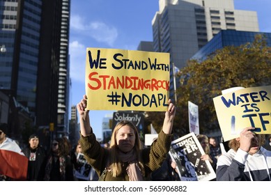 TORONTO - NOVEMBER 5: A Woman Walking With A Solidarity Message During A Rally With The Dakota Access Pipeline Protesters On November 5, 2016 In Toronto, Canada.