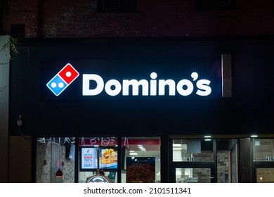 Toronto, ON, Canada – December 13, 2021:  Domino's Pizza Store Front With And Blue Franchise Sign.