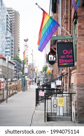 Toronto, ON Canada - June 13 2021: Gay Rainbow Pride Flag Raised Above An Lgbt Store On Church Street. Out On The Street Shop In The Village Of Toronto, Ontario Canada.