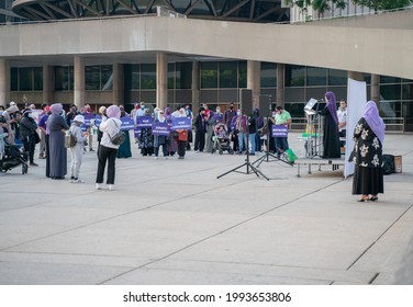 Toronto, ON Canada - June 18 2021: Muslim Association of Canada protesters gather in front of Toronto City Hall with picket signs to mourn the death of the victims from the London terrorist attacks.