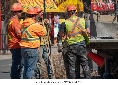 Toronto, ON Canada - March 17 2022: Blue Collar Workers At A Construction Site Doing Training. Three Male Employees Doing Road Work In The Streets Of Toronto, Canada In 2022.