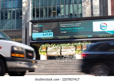 Toronto, ON, Canada - September 9, 2022: At The Base Of A TMX (Toronto Stock Exchange) Office In Downtown Toronto, A Large Digital Stock Ticker Is Seen At The Base As City Traffic, Blurred, Passes By.