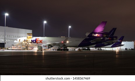 TORONTO, ONTARIO - April 2, 2019: FedEx MD-11 Being Loading With Cargo At Their Toronto Pearson Terminal Late At Night. 