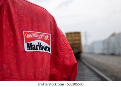 TORONTO, ONTARIO, CANADA - APRIL 30 2017: Man Standing In Rain Wearing Marlboro Rainjacket