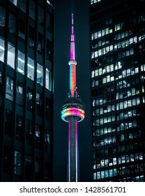 Toronto, Ontario / Canada - June 19 2019:Toronto Financial District City Skyline Skyscrapers With The Famous CN Tower Monument In The Middle Lit Up Pride Colors.
