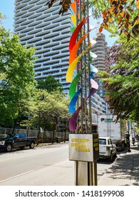 Toronto, Ontario, Canada - June 6, 2019: Toronto City Getting Ready To Pride Parade On Church Street. Festive Rainbow Flag Decoration On Road Post Outside In Church Wellesley Village. 