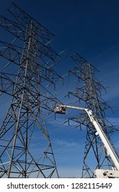 Toronto, Ontario, Canada - March 19, 2015: Hydro Linemen On Cherry Picker Working On A Double Circuit High Tension Power Line Tower