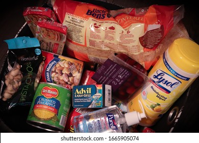 Toronto, Ontario / Canada - March 6, 2020: Emergency preparedness / home quarantine kit with food and medical supplies during coronavirus outbreak. Canned goods, rice, sardines, Advil, and Lysol.