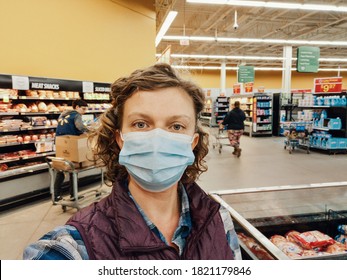 Toronto, Ontario, Canada - May 17, 2020: Woman Customer In Protective Face Mask Shopping At Grocery Store. Safety Measures Against Coronavirus Covid-19 Virus Spread. New Normal. 