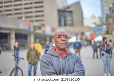 Toronto Ontario, Canada- May 19th, 2022: A Black Man Listening To A Speaker During The Vigil About The Shooting In Buffalo New York, While At Toronto City Hall’s Nathan Philips Square.