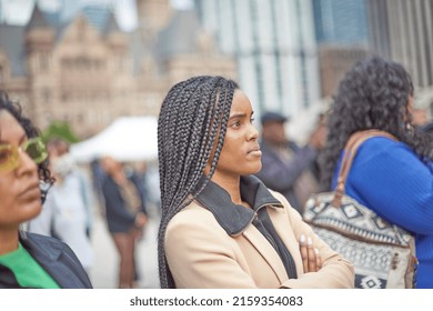 Toronto Ontario, Canada- May 19th, 2022: A Black Lady Listening To The Vigil About The Shooting In Buffalo New York At Toronto City Hall’s Nathan Philips Square.