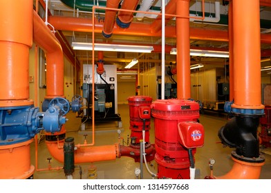 Toronto, Ontario, Canada - May 27, 2009: Row Of Furnaces And Hot Water Pipes In The Boiler Room Of A Highrise Office Building